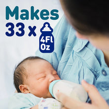 [39549990142123]Person holding a baby and a bottle with text indicating bottle capacity.