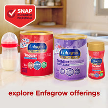 Enfagrow Toddler nutritional drinks on a kitchen counter with a bottle of milk.